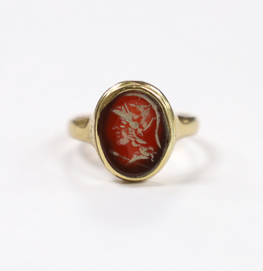 An antique 9ct and intaglio glass? set oval ring, depicting the bust of a Roman soldier to dexter, size P, gross weight 3.8 grams.